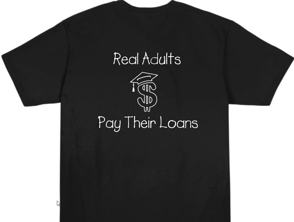 black t-shirt with the phrase "Real Adults" above a money symbol wearing a graduation cap, and the words "Pay Their Loans" underneath.